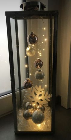 a display case with ornaments and lights in it