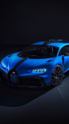 a blue bugatti is shown in the dark