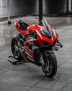 a red and black motorcycle parked on the street