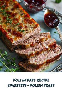 two slices of meatloaf sitting on top of a blue plate next to sauce