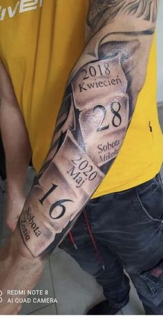 a man with a tattoo on his arm that has the date in roman numerals