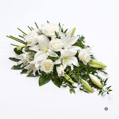 a bouquet of white flowers sitting on top of a table