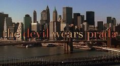 the devil wears prada sign is in front of a cityscape and bridge