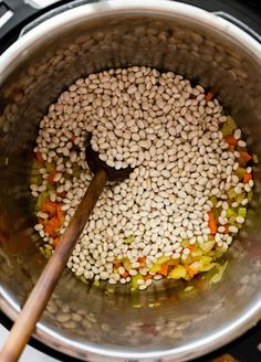 beans and carrots are being cooked in an electric pressure cooker