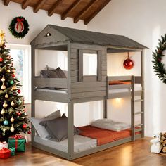 a wooden bunk bed next to a christmas tree