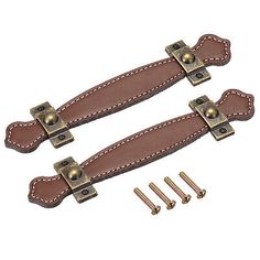 two brown leather straps with brass hardware and screws on each side, one is open