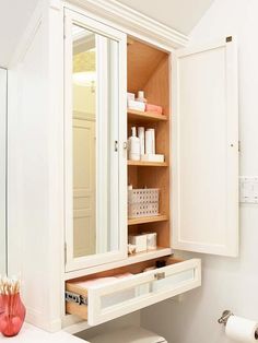 a bathroom with a sink, toilet and medicine cabinet in it's center area