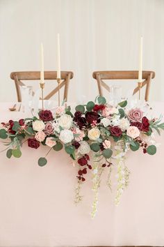 the table is set with flowers and candles