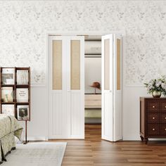 a bedroom with white walls and wooden flooring next to a bed in a room