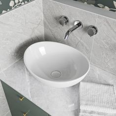 a white sink sitting on top of a bathroom counter