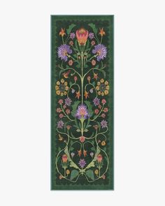 an embroidered wall hanging with flowers and leaves on the side, in dark green background