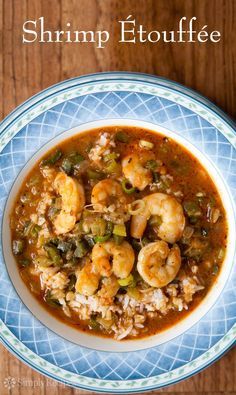 shrimp etouffe in a blue and white bowl on a wooden table with text overlay