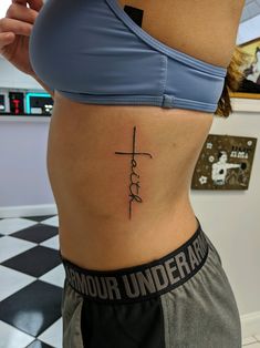 a woman with a cross tattoo on her stomach