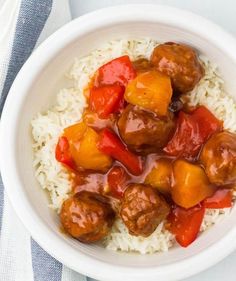 a white bowl filled with meatballs and rice