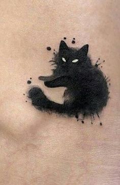 a black cat tattoo on the stomach