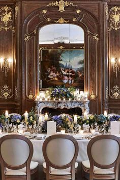 an elegant dining room set up with candles and flowers