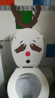 a toilet with a reindeer face painted on it