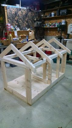 a wooden house being built in a workshop