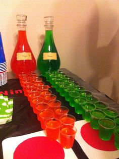 there are many glasses lined up on the table to be filled with drinks and condiments