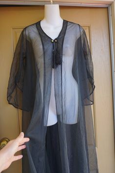 "Vintage black sheer robe. 70s era. Great condition. Measurements taken across front laid flat 20\" across front armpit to armpit -doubles to 40 around 37\" across waist 52\" length" Bohemian Sheer Cover-up For Party, Sheer Long Sleeve Festival Cover-up, Long Sheer Cover-up For Party, Black Sheer Bohemian Cover-up, Black Sheer Robe, Embroidery Aprons, Sheer Robe, Womens Lingerie, Romantic Boho