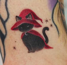 a black cat with a red hat on it's head