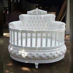 a white baby crib sitting on top of a floor