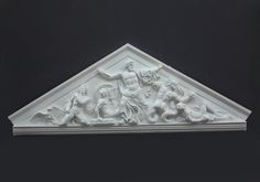 a white sculpture is on display against a black background with the image of jesus and other figures