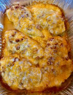 two pieces of cheese covered bread in a foil container