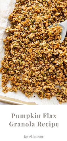 pumpkin flax granola recipe on a sheet of parchment paper with a spoon in it