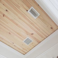 an air vent is mounted to the wooden ceiling