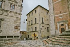 an old stone building with steps leading up to it