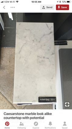 a marble look tile counter top with potential advertisment on the bottom right hand corner