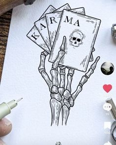 a drawing of a skeleton holding cards with the word karma written on it in black ink