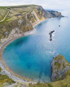 an aerial view of the blue water and cliffs