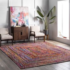 a living room with two chairs and a rug