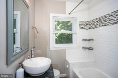 a bathroom with a sink, toilet and bathtub