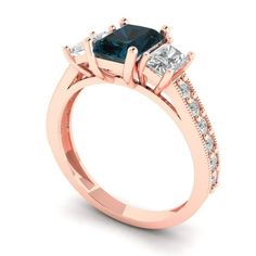 a rose gold engagement ring with two princess cut diamonds on the sides and side stones