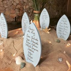 the table is set up with place cards and seashells for guests to write their names