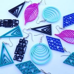 six pairs of earrings with geometric designs on them