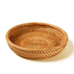 a round woven basket on a white background