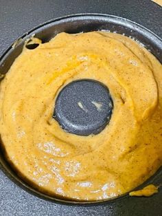 a food processor filled with yellow sauce on top of a table