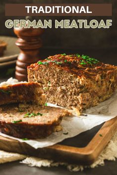 a meatloaf cut in half on top of a cutting board with the words traditional german meatloaf