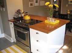 a kitchen with an island and stove top