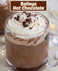 there is a hot chocolate drink with whipped cream in the cup and toppings on top