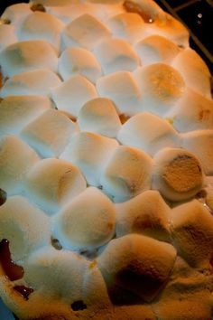 a pie with marshmallows on top is sitting on a rack in the oven