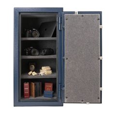 an open safe with books and cameras inside