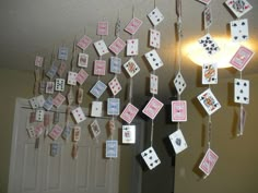 some cards are hanging from the ceiling in front of a door with lights on it