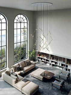 a living room with large windows and furniture