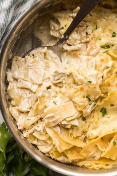 a large pot filled with pasta and chicken