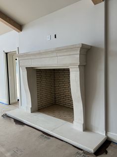 an empty fireplace in the middle of a room